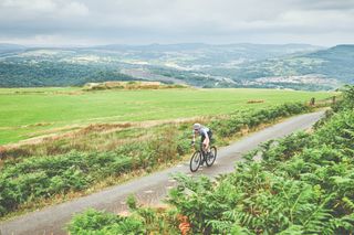 Female cyclist rides solo through countryside