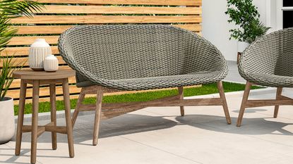 A rattan-effect egg chair in an outside living space