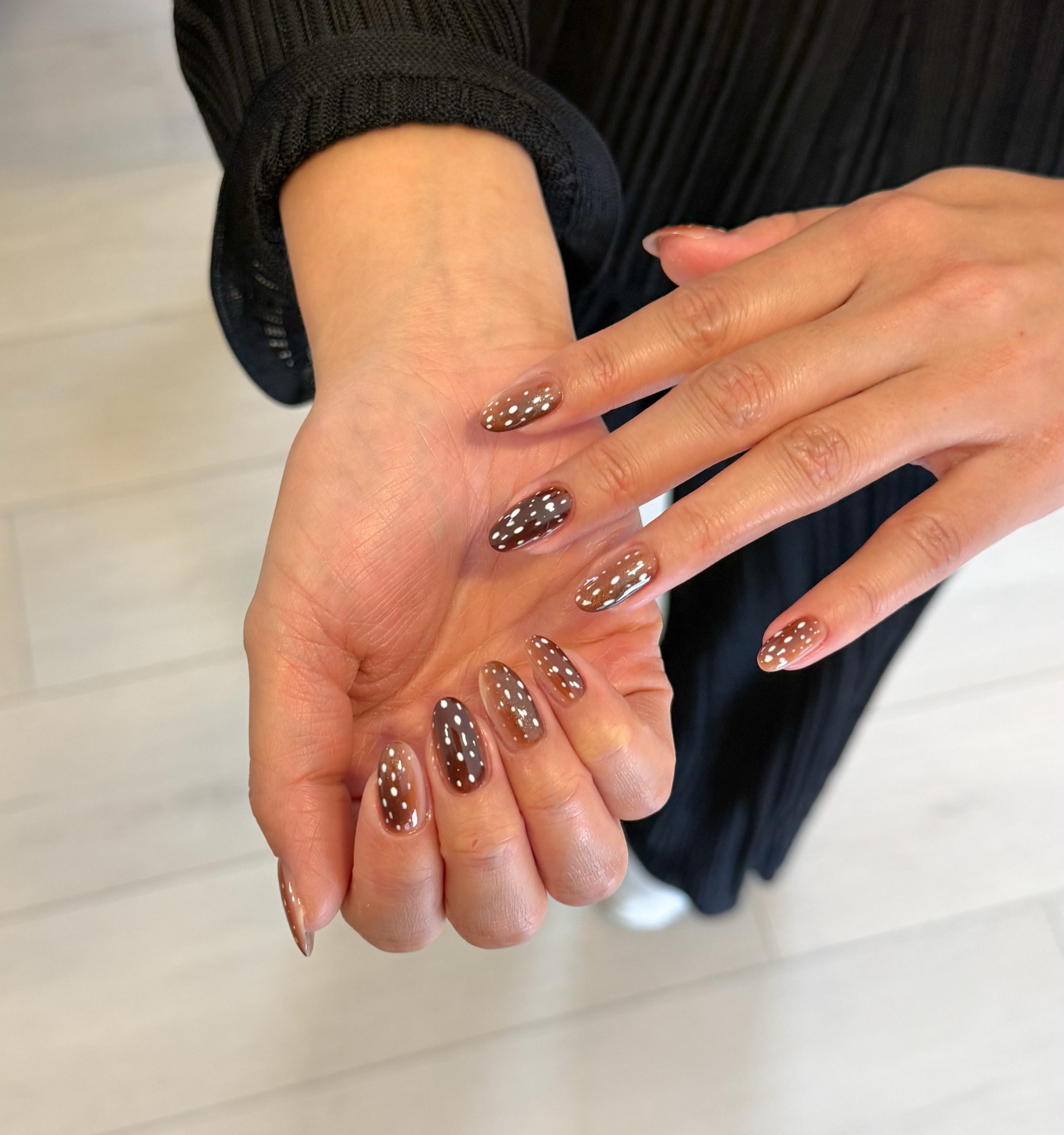 brown bambi inspired manicure with tiny cream spots scattered across glossy nails