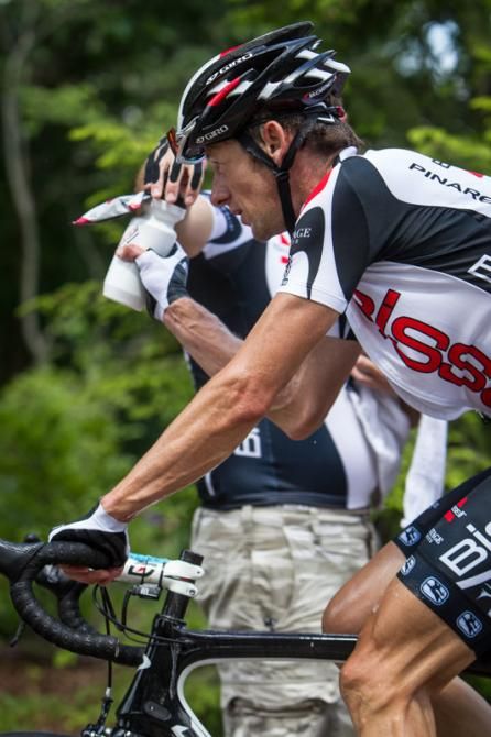 Jason McCartney (Bissell) grabs a water bottle before he hits the descent.