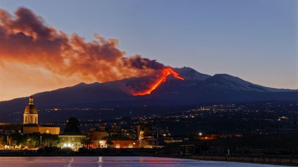 Red lava streams down the side of Mount Etna in Sicily.