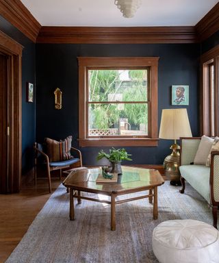 navy blue living room with dark wood accent trims and cozy seating