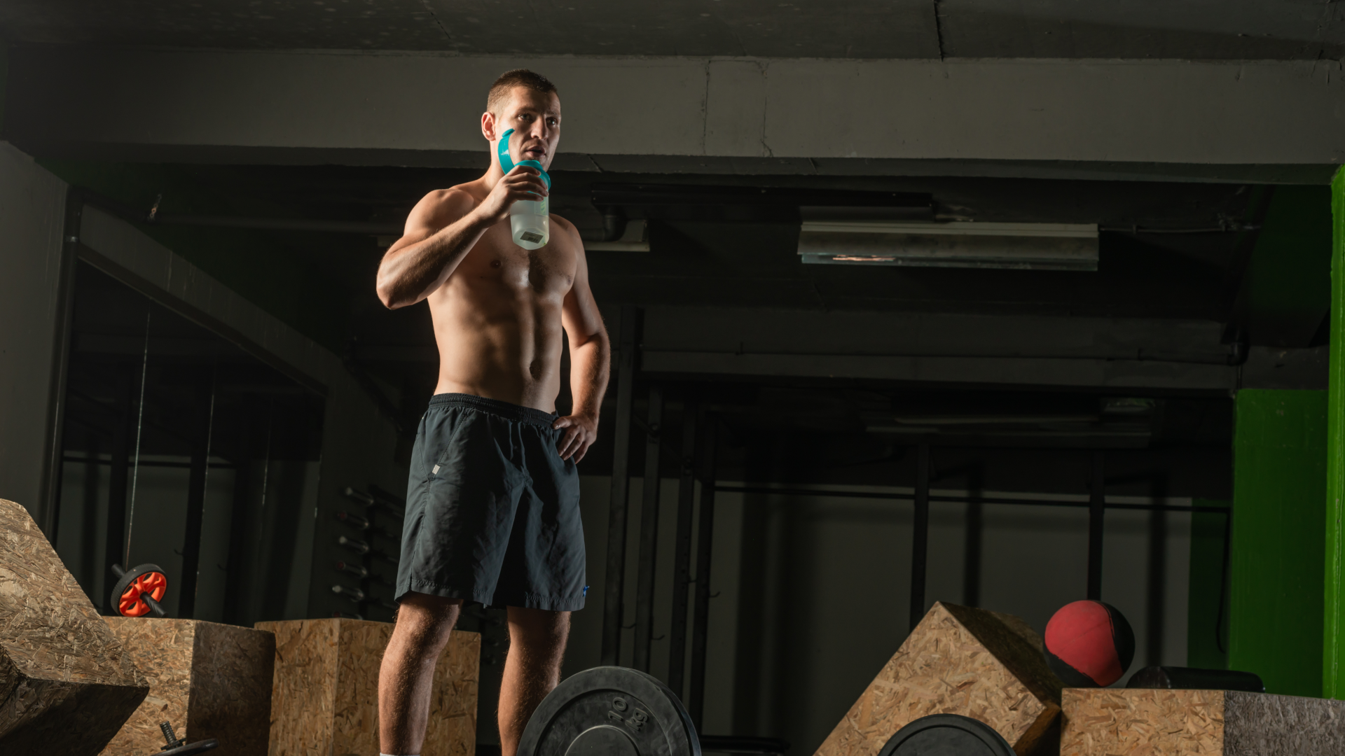 A man drinking some electrolytes at the gym
