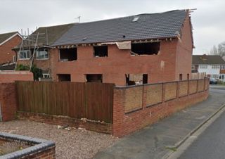 The rear of a shell of a brick self build home