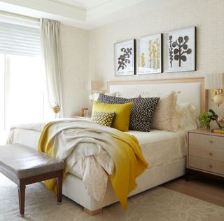 Yellow and cream bedroom with a mix of textures on cushions, the rug and lampshades