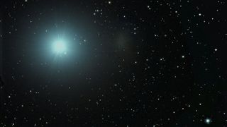 pale blue bright light against starry background