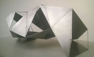 A silver, geometric structure with open panels