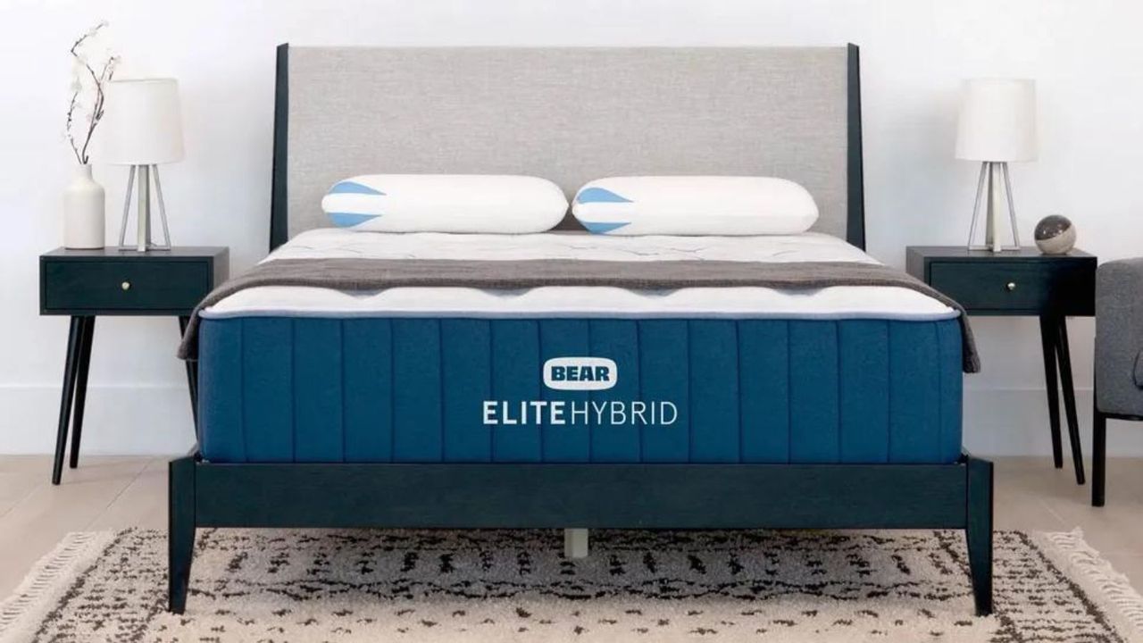 One of the best box mattresses, the Bear Elite Hybrid Mattress, on a bed against a white wall.