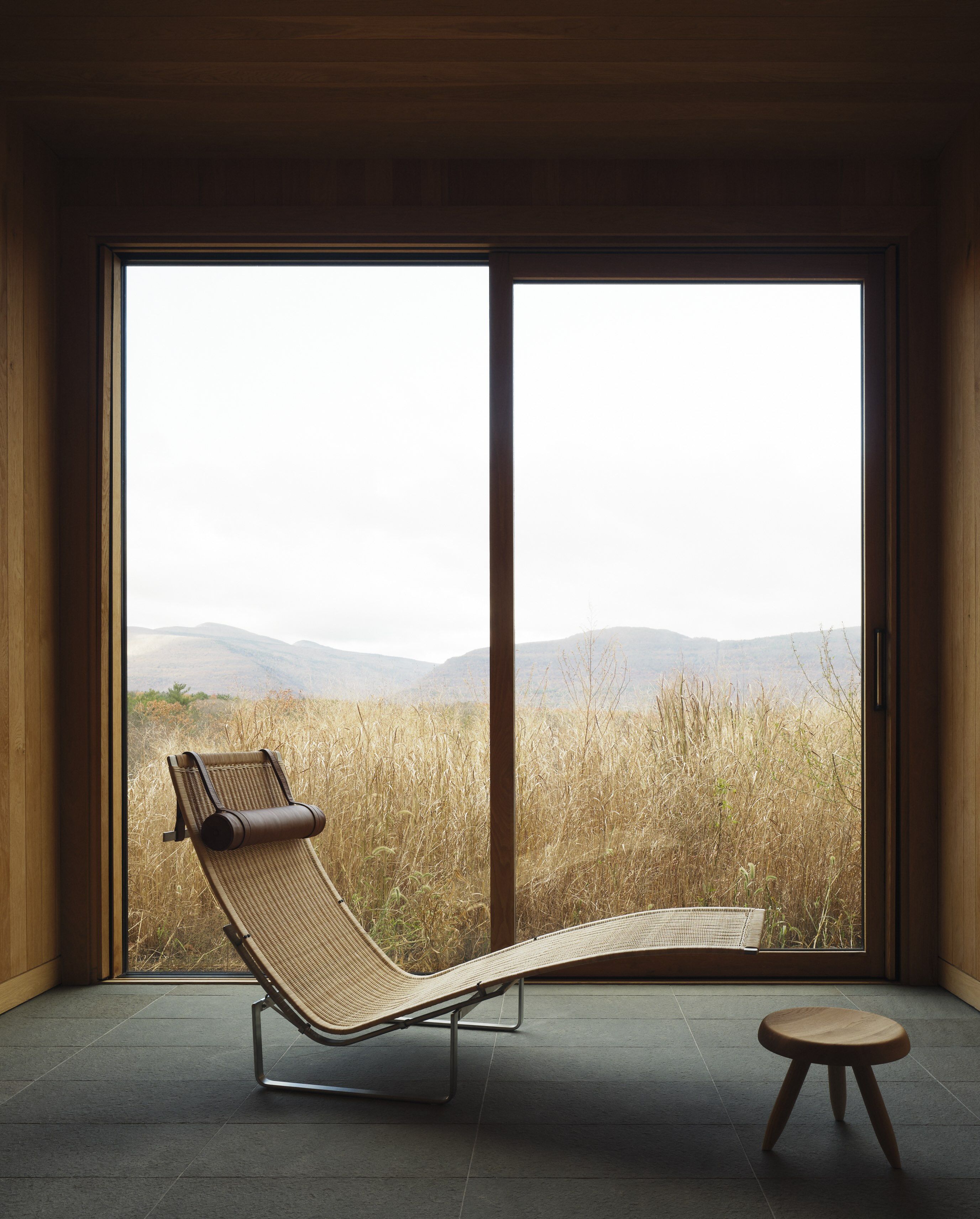 A sculptural lounge chair sits in front of the window within the Piaule hotel&#039;s spa.