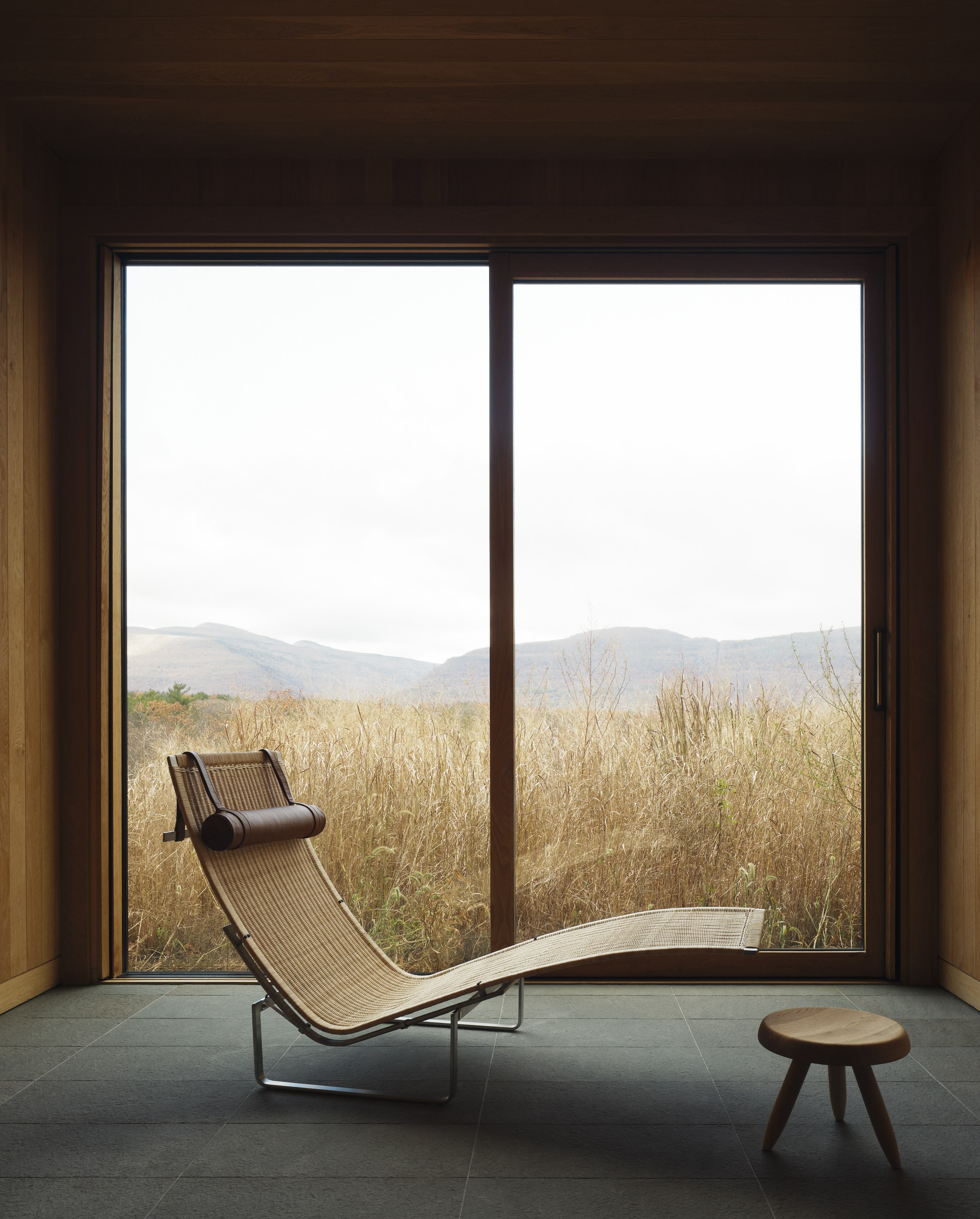 A sculptural lounge chair sits in front of the window within the Piaule hotel's spa.
