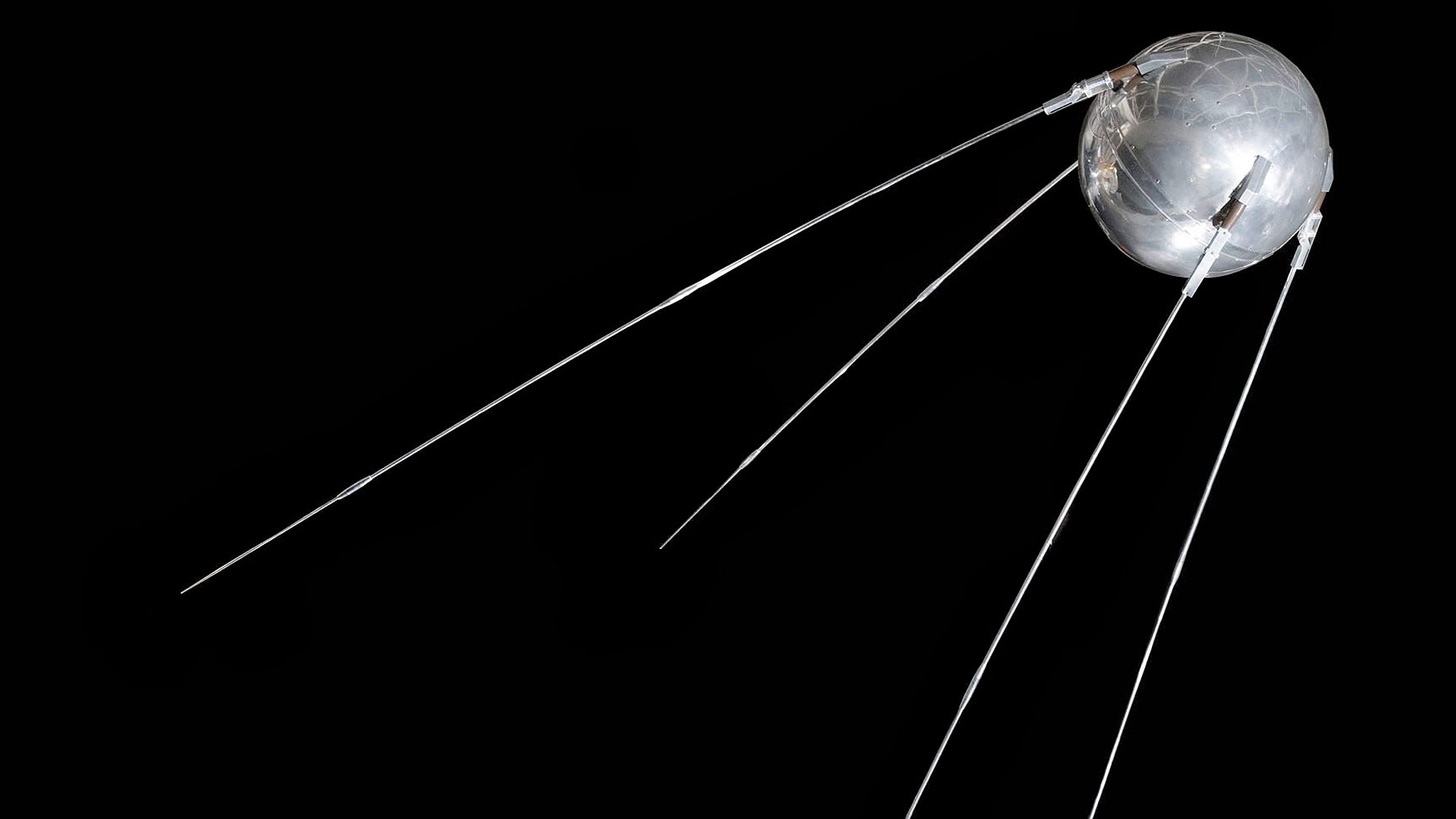 a silver spherical satellite with four protruding antenna
