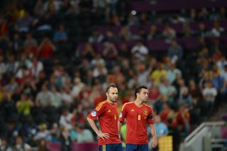 Spanish midfielders Andres Iniesta (L) and Xavi Hernandez wait for the start of the Euro 2012 football championships semi-final match Portugal vs Spain on June 27, 2012 at the Donbass Arena in Donetsk.