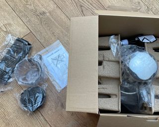 Inside of Nutribullet Pro Juicer packaging, containing parts wrapped in plastic packaging