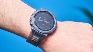 A black and gray Amazfit Active Edge GPS fitness tracker on a person's wrist