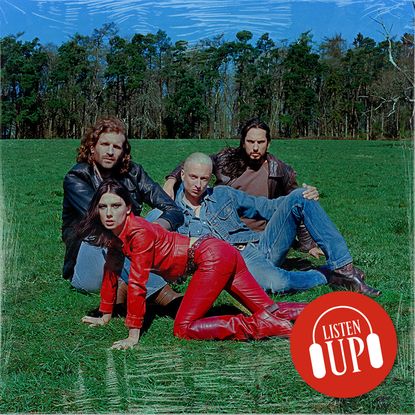 a posed shot of the band wolf alice sitting in a green field with front woman ellie rowsell wearing a red leather outfit and crawling on all fours with the treated marie cliare listen up franchise logo on top