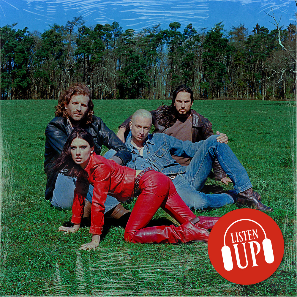 a posed shot of the band wolf alice sitting in a green field with front woman ellie rowsell wearing a red leather outfit and crawling on all fours with the treated marie cliare listen up franchise logo on top