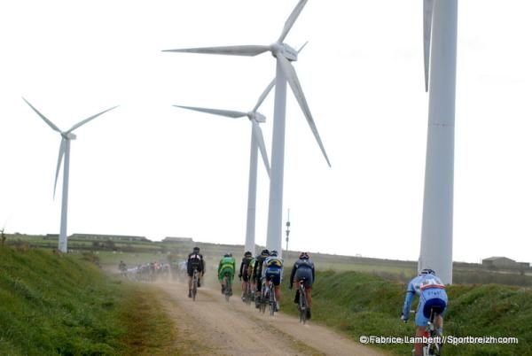The peloton dwarfed by the wind farm in Tro-Bro Leon