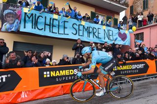 Dario Cataldo rides past a banner honouring forrmer Astana teammate Michele Scarponi