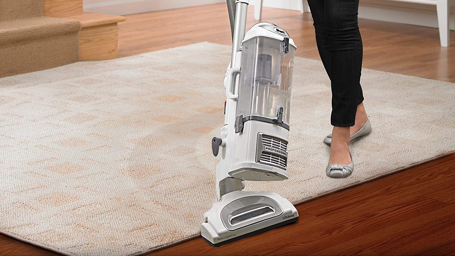 Woman using Dyson upright vacuum cleaner
