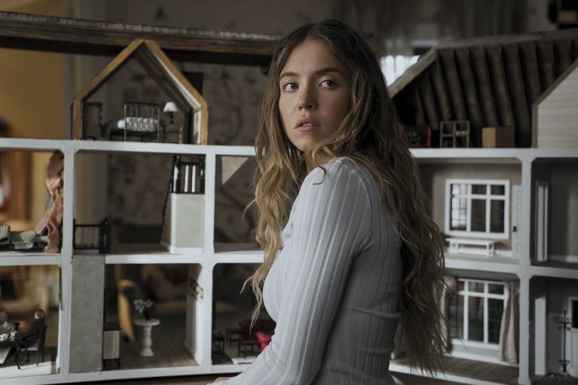 Sydney Sweeney standing by a dollhouse in The Housemaid