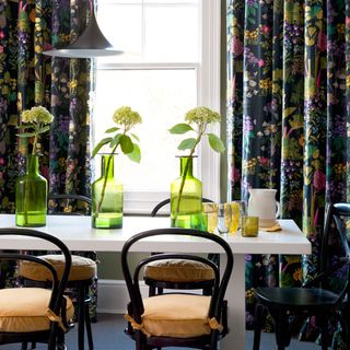 dining room with black floral curtains