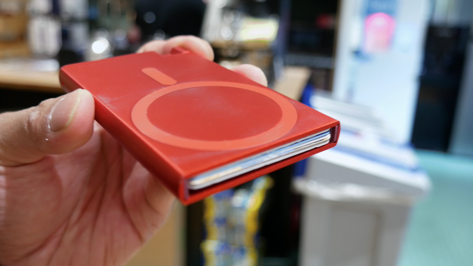 Ekster Cardholder Pro for MagSafe dealing out cards.