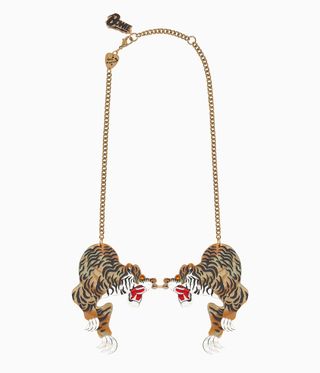 Gold necklace with tigers on,