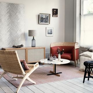 living room with wooden chair and photoframe on white wall