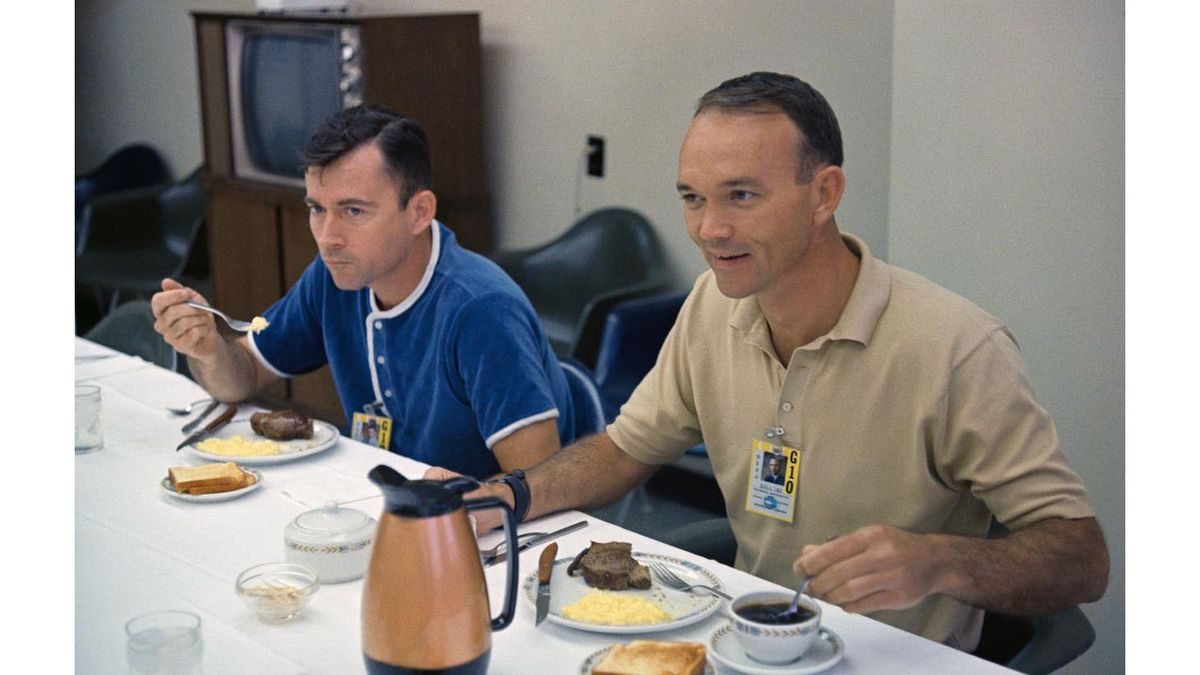 The Gemini 10 crew, Astronauts John W. Young (left) and Michael Collins (right), enjoy breakfast before launch.