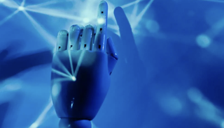 A robot hand pushing a button.