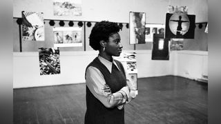 Heather Agyepong stands in a gallery 