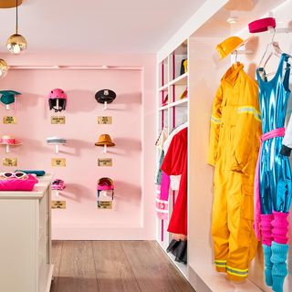 dressing room with wardrobe and pink wall