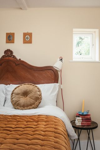 wooden antique headboard in cottage guest bedroom