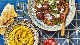 BBQ food on dining table with falafel and side dishes