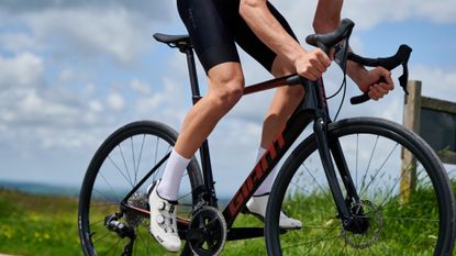 Male cyclist riding his bike outside on a country lane