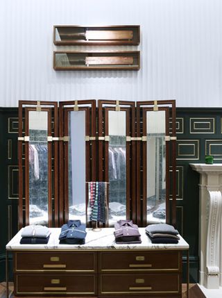 Aged mirrors and refined marble topped cabinets finish the space