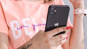 iPhone being held by woman in pink top