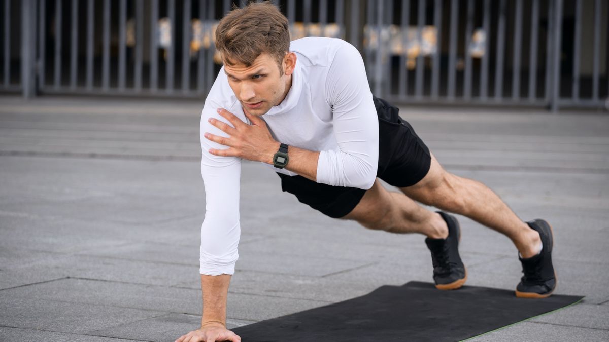 Man doing plank shoulder tap exercise