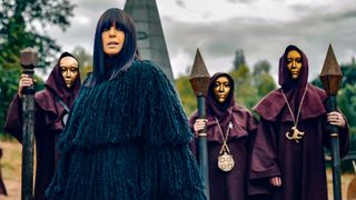 Host Claudia Winkleman flanked by druids in The Traitors season 2