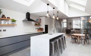 Within this terraced house the entire ground floor layout has been opened up, with the use of partial glazed divides creating zones within the space