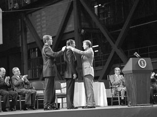 Photo of Neil Armstrong receiving space medal of honor from President Jimmy Carter.