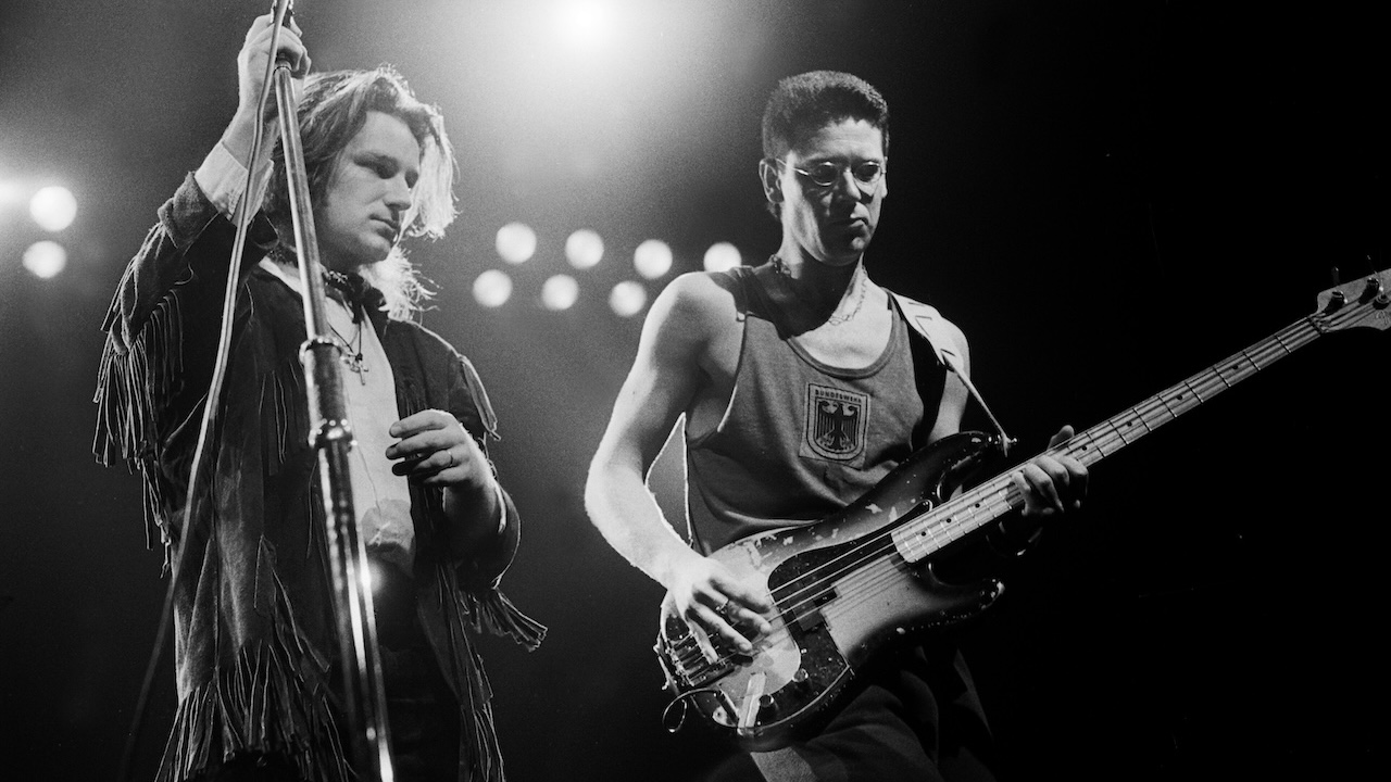 Bono (born Paul Hewson) (left) and Adam Clayton, both of the group U2, perform onstage during the Amnesty International benefit concert at the Rosemont Horizon, Rosemont, Illinois, June 12, 1986