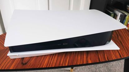 PS5 console on a wooden table