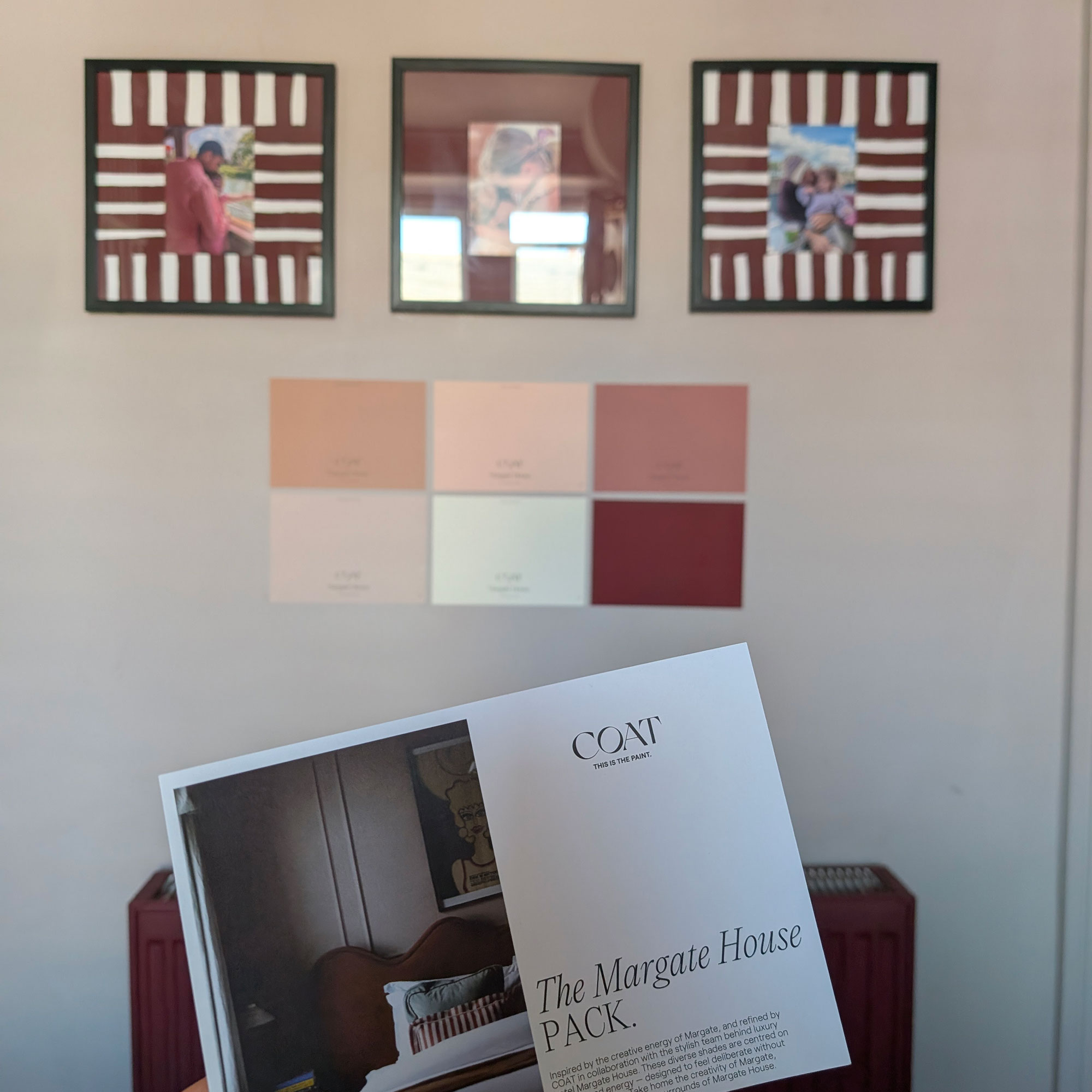 Six paint samples on wall beneath three framed photographs