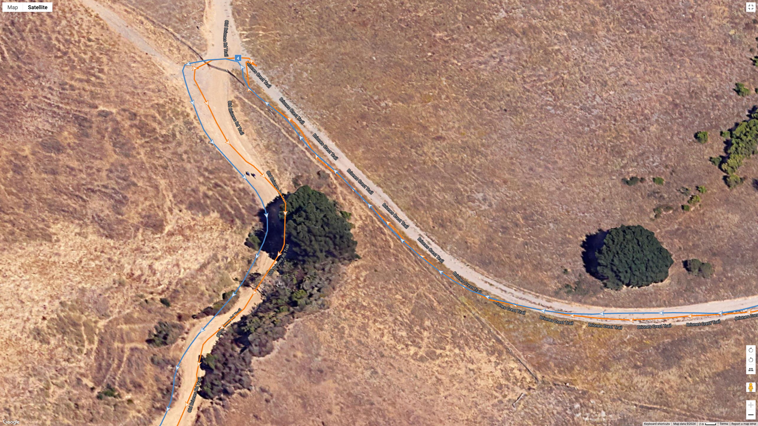 A Google Earth satellite image showing how the COROS PACE Pro (blue line) compares to the Garmin Fenix 8 (orange line) for a dual-band GPS accuracy test.