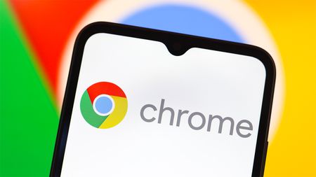 Google Chrome logo displayed on smartphone screen, with larger logo behind