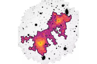 An image of purple and orange blobs overlaid over a map of galaxies