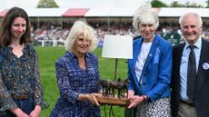 The Queen at Badminton Horse Trials in 2024, making a presentation to event director Jane Tuckwell to mark her 50 years working at the event.