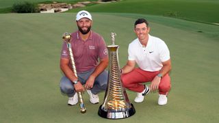 Jon Rahm with the DP World Tour Championship trophy and Rory McIlroy with the Harry Vardon Trophy