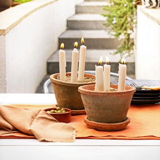 candles in brown pots and plates